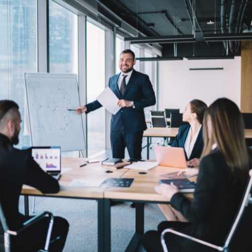 Executive leading a strategy presentation in a boardroom